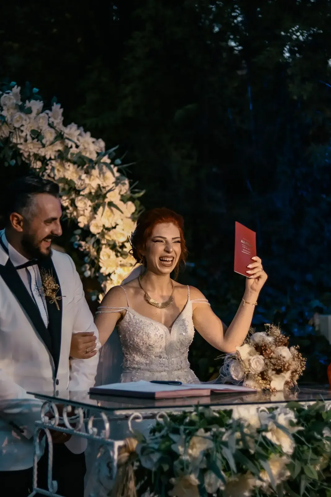 Happy couple exchanging vows at an elegant outdoor wedding ceremony.