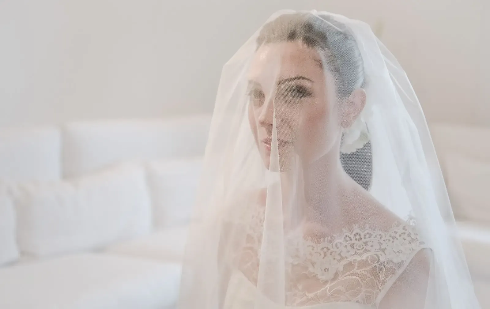 A beautiful bride in a lace wedding dress and veil, reflecting elegance and grace.