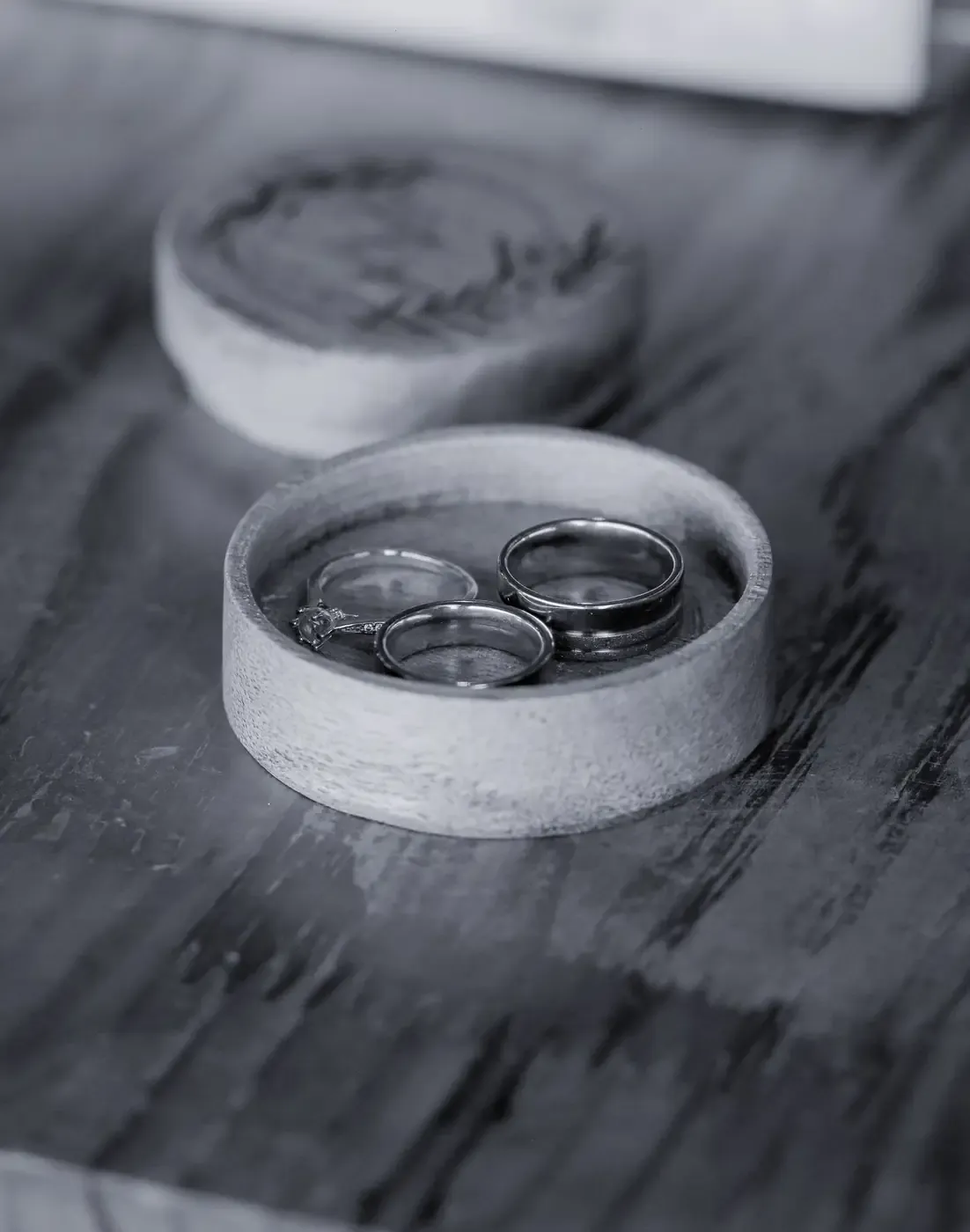 Close-up of luxurious wedding rings in an intricately crafted wooden box, perfect for a ceremony.